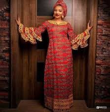Model posing in a stylish long veil with floral patterns